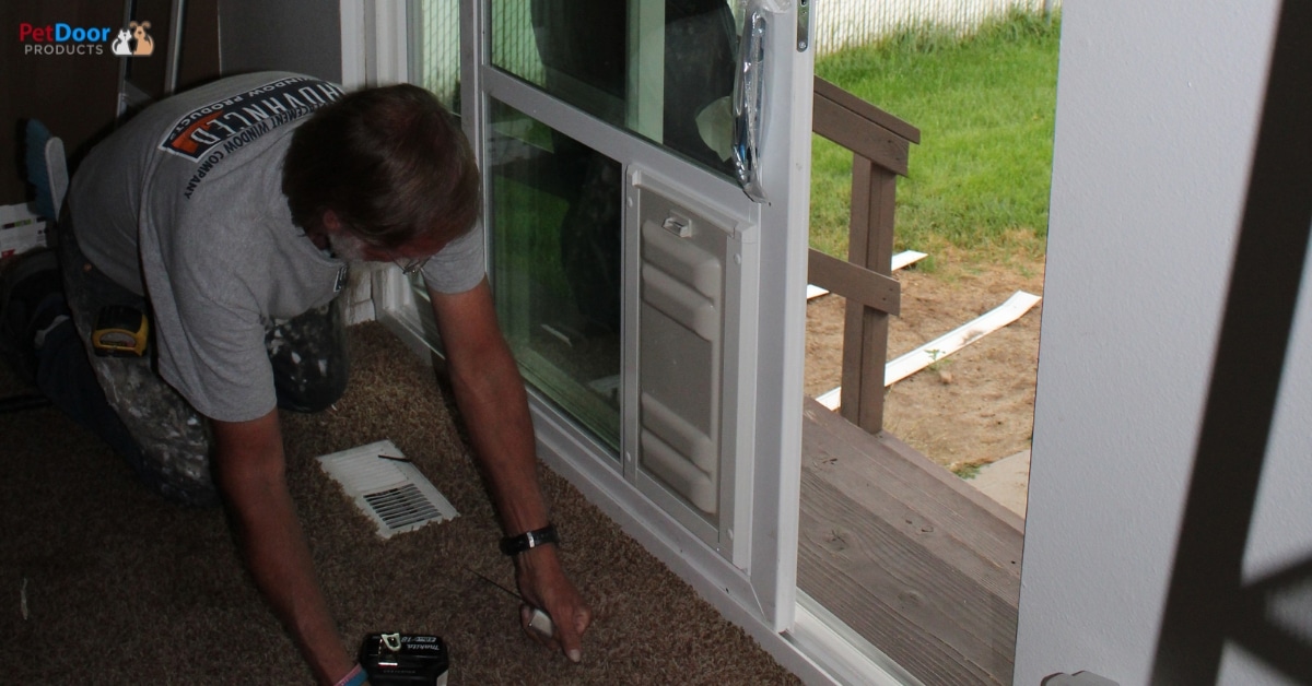 Dog using a large sliding glass door pet door in Utah