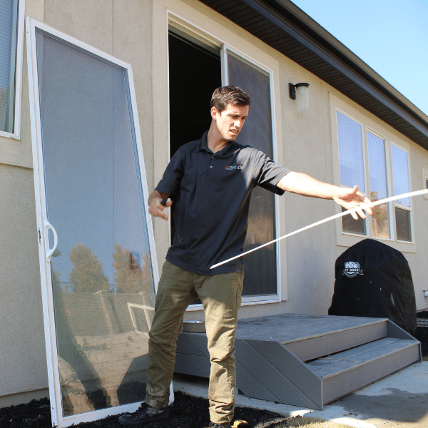 Dog owner measuring their pet to find the correct dog door size.